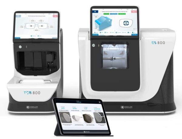 Two modern, white Essilor ES 800 and ES 800M Lens Edging Systems with integrated digital displays, accompanied by a tablet showing user interface options.
