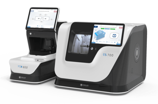 Two modern Essilor ES 700 and ES 700M Edging Systems, labeled tcr 800 and es 700, with digital screens displaying eye exam data.