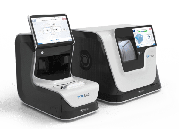 Two modern Essilor ES 700 and ES 700M Edging Systems on a green background, models tr-800 and ts-100, each featuring a touchscreen display.