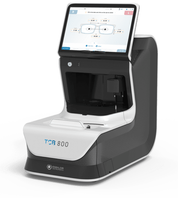 A modern Essilor ES 700 and ES 700M Edging Systems lens measurement device with an integrated display screen, featuring an open data input interface.